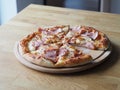 baked and sliced Ã¢â¬â¹Ã¢â¬â¹pizza with cheese, ham and sauce